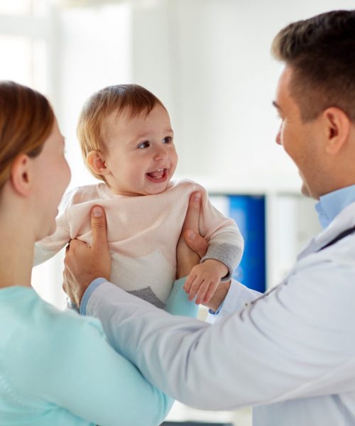 medicine, healthcare, pediatry and people concept - happy woman with baby and doctor at clinic